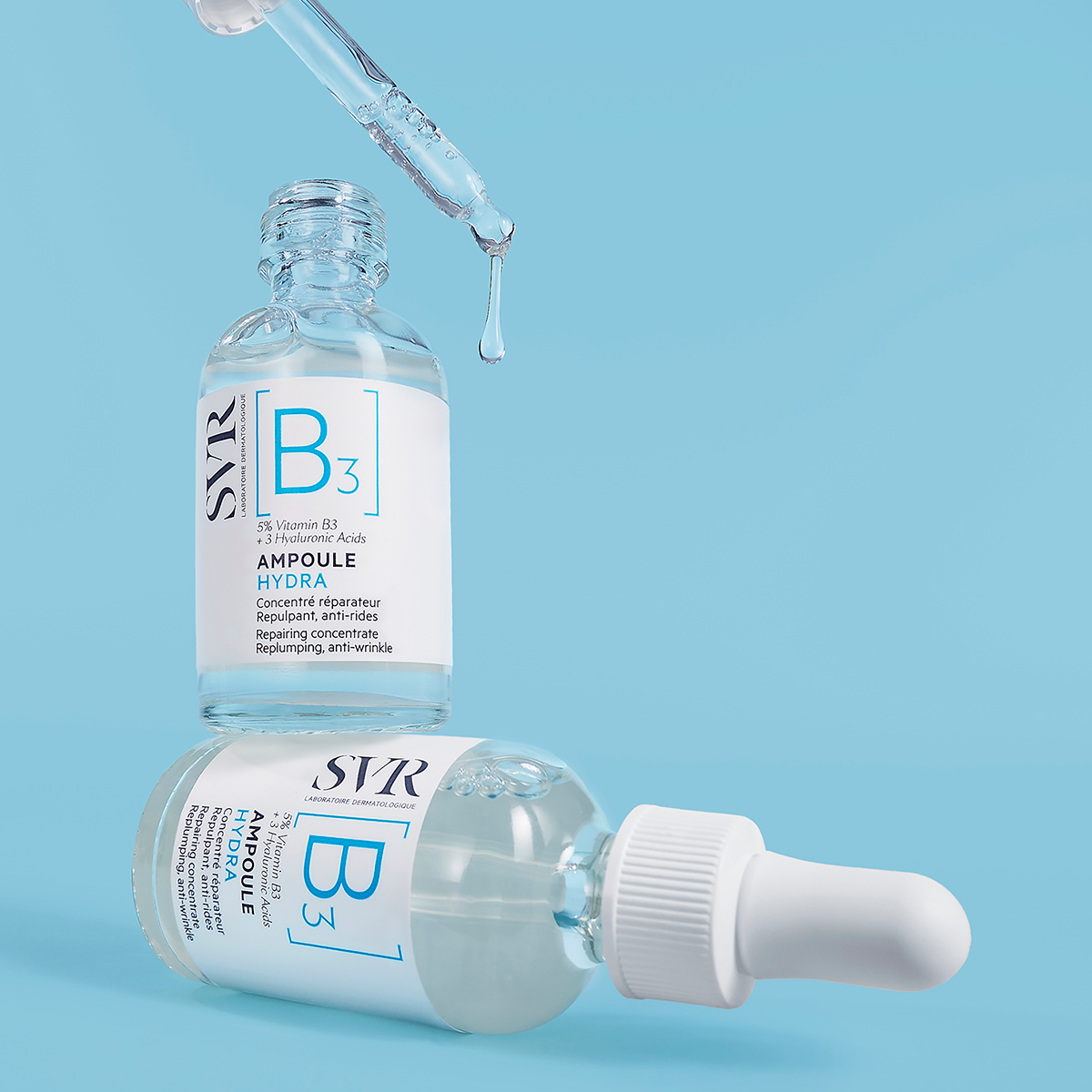 Two SVR Ampoule Hydra serum bottles with glass droppers and white caps on a light blue background.