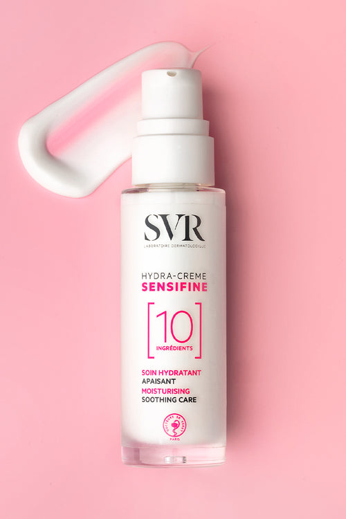 SVR Sensifine Hydra-Crème pump bottle with a white cream smear on a soft pink background.