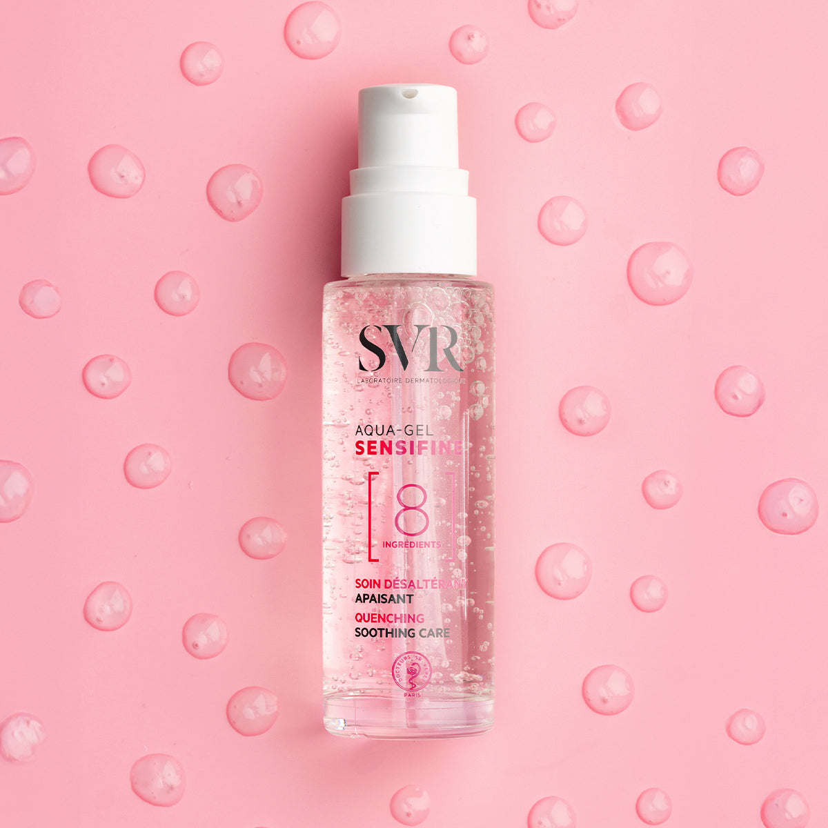 SVR Sensifine Aqua-Gel in a clear pump bottle surrounded by water droplets on a soft pink background.